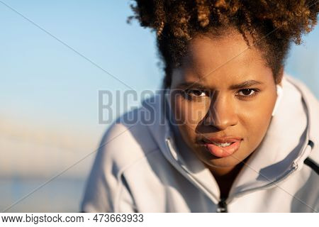 Portrait Of Motivated Young Black Female In Sportswear Posing Outdoors