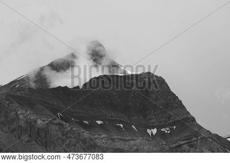 Monochrome Image Of Fog Creeping Around Mount Oldehore.