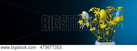 Happy Easter Conzept. Bouquet Of Spring Yellow Flowers Jasminum Nudiflorum On Blue Background With E