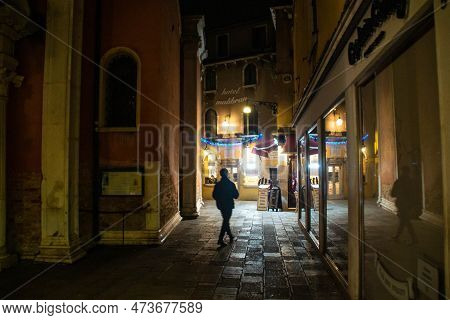Venice, Italy - January 19, 2023: Man Walking On Corte Del Teatro Malibran Street At Night