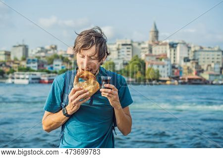 Man In Istanbul Having Breakfast With Simit And A Glass Of Turkish Tea. Glass Of Turkish Tea And Bag