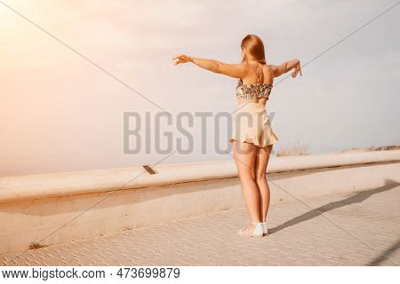 Woman Summer Dance. Silhouette Of A Happy Woman Who Dances, Spins And Raises Her Hands To The Sky. A
