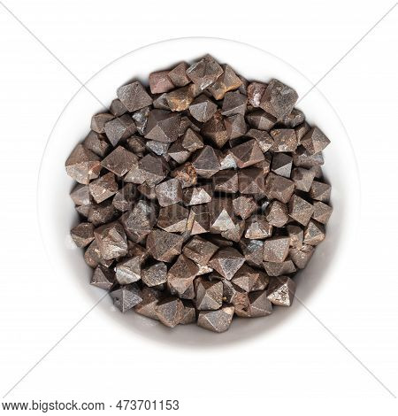Magnetite Crystals In A White Bowl. Iron(ii,iii) Oxide, Octahedral, Double Pyramid And Platonic Soli