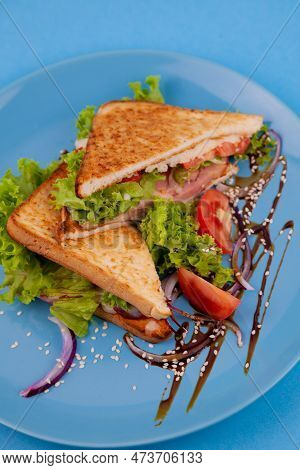 Breakfast Sandwich Toast With Salad. Blue Background. Bread, Beakon Tomatoe On Plate Top View. Meat 