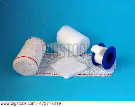 Various Dressing Materials Isolated On A Blue Background. Home First Aid Kit.