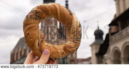 Tourist Woman Eating Bagel Obwarzanek Traditional Polish Cuisine Snack Waling On Market Square St. M