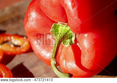 Red Bell Pepper On A Wooden Board. Bright, Healthy Vegetables. A Constrate Photo Of A Bell Pepper Wi