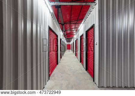 Corridor Of Self Storage Unit With Red Doors. Rental Storage Units