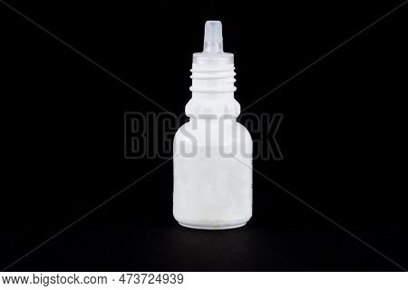 Picture Of A White Medical Bottle Isolated On A Black Background. Also Called Squeezer Bottle Or Dro