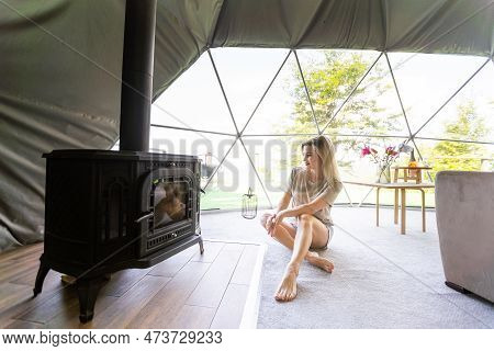 Transparent Bubble Tent At Glamping, Lush Forest Around And Interior. Woman Resting In Glamping