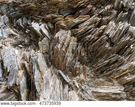 Stone Close-up, Stone Background. Compressed Rock Layers Formation In Various Colors And Thicknesses