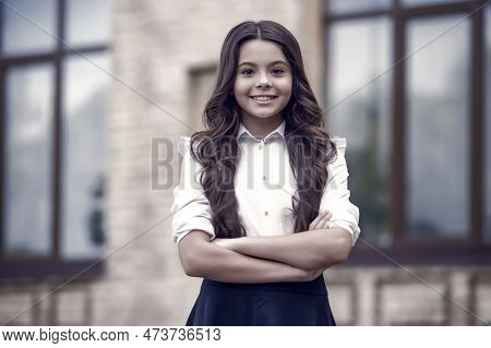 Dedicated To Learning. Confident Lyceum Student Keep Arms Crossed Outdoors. Happy Child Study In Lyc