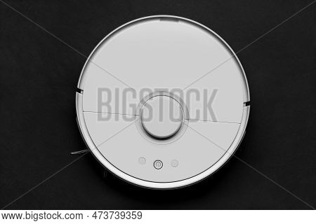 Modern Autonomous Smart Robot Vacuum Cleaner On A Black Background, Top View. Self-propelled Cleanin