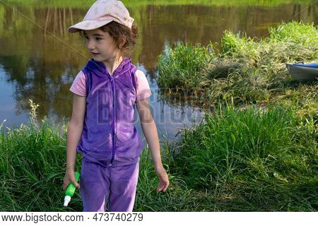 Girl Uses A Remedy For Mosquitoes And Biting Insects In Nature. Protection Of The Skin From Tick Bit