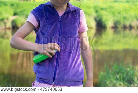Girl Uses A Remedy For Mosquitoes And Biting Insects In Nature. Protection Of The Skin From Tick Bit