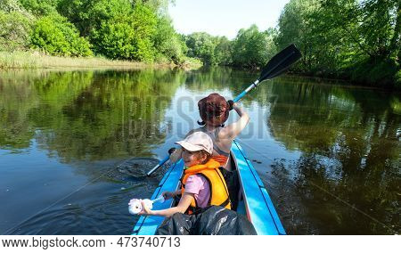 Family Kayak Trip. Mom And Daughter Rowing A Boat On The River, A Water Hike, A Summer Adventure. Ec