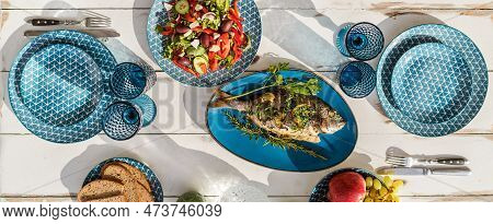 Gilt-head Bream Also Known As Orata Baked In The Oven And Served On A White Wooden Table With Vegeta