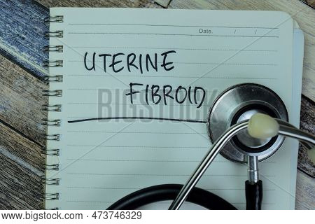 Concept Of Uterine Fibroid Write On Book With Stethoscope Isolated On Wooden Table.