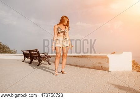 Woman Summer Dance. Silhouette Of A Happy Woman Who Dances, Spins And Raises Her Hands To The Sky. A