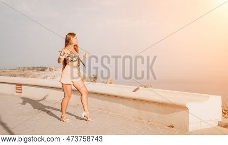 Woman Summer Dance. Silhouette Of A Happy Woman Who Dances, Spins And Raises Her Hands To The Sky. A
