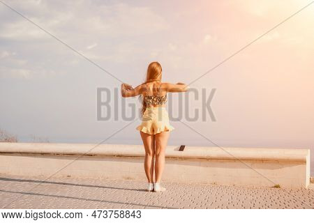 Woman Summer Dance. Silhouette Of A Happy Woman Who Dances, Spins And Raises Her Hands To The Sky. A