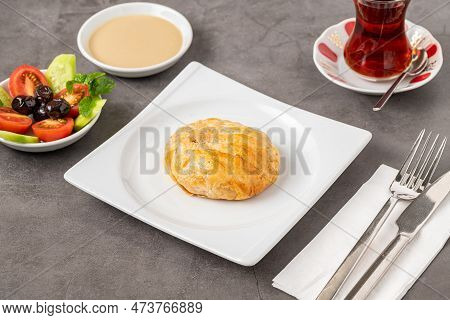 Izmir Boyoz On A White Porcelain Plate On A Stone Table