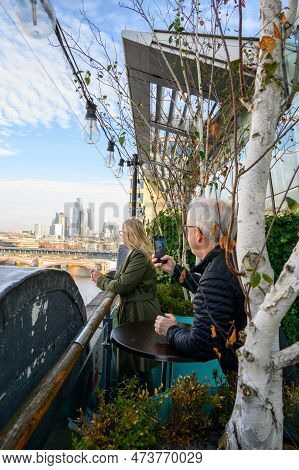 See London Through The Eyes Of A Woman As She Enjoys The Panoramic View From Oxo Tower's Terrace.