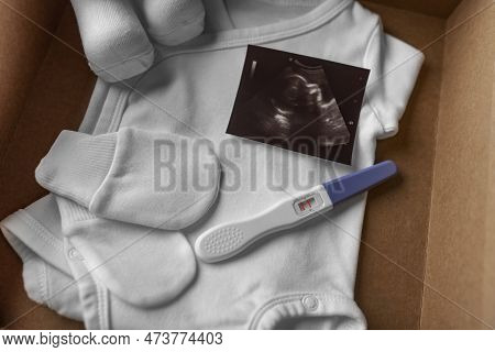 Box With Baby Stuff And Pregnancy Test. Waiting For A Baby.