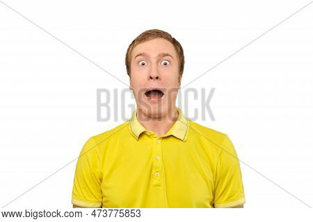 Surprised Young Man With Funny Facial Expression In Yellow T-shirt, White Isolated Background. Shock