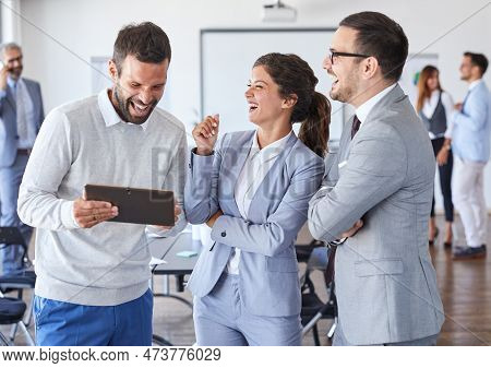 A Portrait Of A Young Businesspeople Holding A Tablet And Smiling During A Meeting And Presentation 