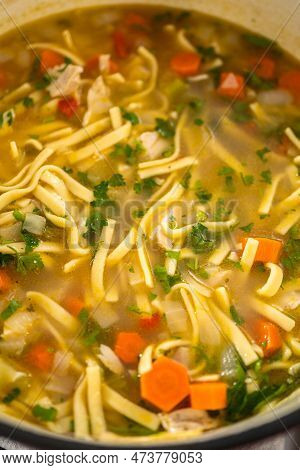 Serving Chicken Noodle Soup With Kluski Noodles In White Ceramic Soup Bowls.