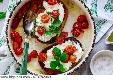 Bruschetta With Buratta And Baked Cherry Tomatoes.top View.selective Focus