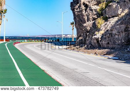 Bikeway Along Federal Highway 11 Towards Del Ruso Viewpoint, Sea And Industrial Complex Against Blue