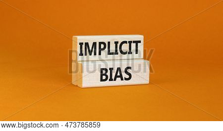Implicit Bias Symbol. Concept Words Implicit Bias On Wooden Block. Beautiful Orange Table Orange Bac