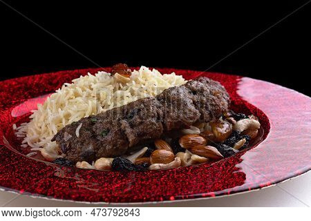 Colorful Pilaf With Tender Kabobs, Caramelized Nuts, And Raisins