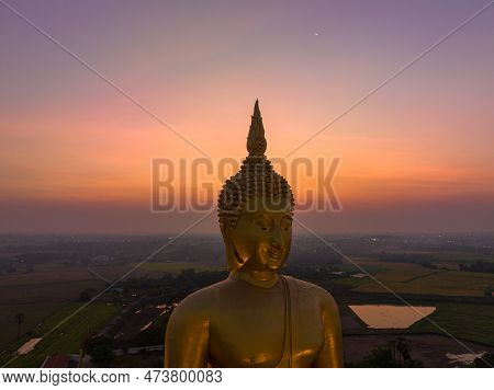 Scenery Sunset Behind The Great Golden Buddha Landmark Of Thailand At Wat Muang Ang Thong Thailand. 