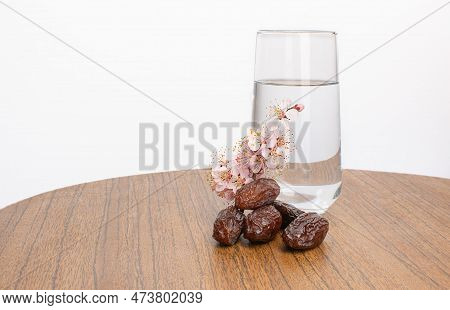 Ramadan Muborak, A Glass Of Water Dates And Apricot Branch Bloom
