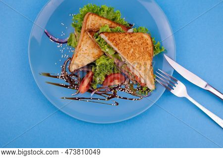 Breakfast Sandwich Toast With Salad. Blue Background. Bread, Beakon Tomatoe On Plate Top View. Meat 