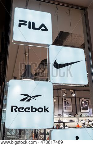 Reebok, Nike And Fila Logos Of Popular Footwear And Clothing Brands In The Interior Of A Multi-brand