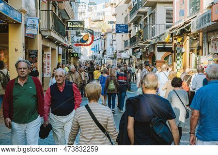 Benidorm, Spain - 01 April, 2023: People Walking And Enjoy Sunny Day On The Shopping Street In Benid