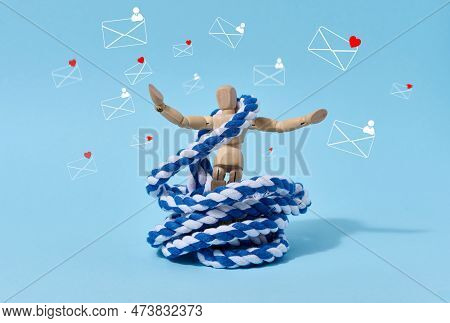 Wooden Mannequin Untangles Rope And Letter Icons On Blue Background. The Concept Of Releasing Addict