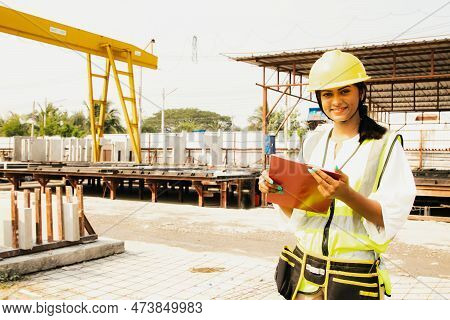 Attractive 20 Year Old Leadership Beautiful Indian Female Worker Wearing Hard Hat Holding Clipboard 