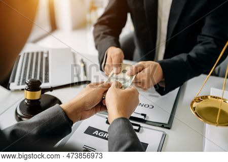 Justice And Law Concept.passing Bribe Money In The Envelop At Lawyer Office.