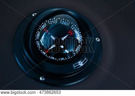 Marine Gyrocompass Mounted On The Black Hull Of The Yacht, Close-up. Yacht Navigation Equipment.