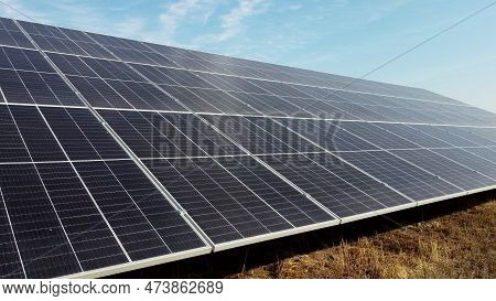 Solar Power Plant. Flight Over Modules Of Solar Power Station On Sunny Day. Renewable Electrical Ene