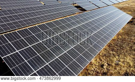 Solar Power Plant. Flight Over Modules Of Solar Power Station On Sunny Day. Alternative Green Electr