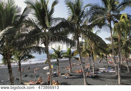 Puerto Naos,la Palma-september 12,2018:tourists On The Black Volcano Beach Of Puerto Naos, La Palma,