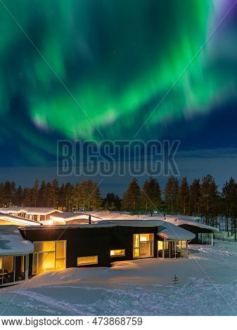 Aurora Over A Cottage In Wintertime In Kuusamo, Finland.