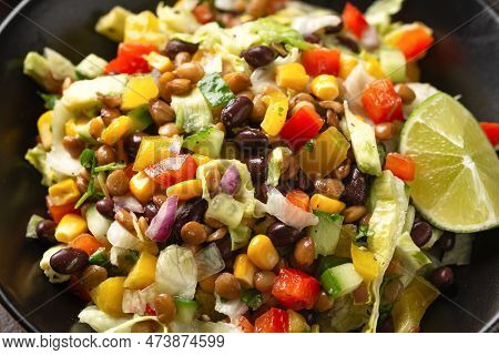 Mexican Style Salad Of Black Beans, Lentils, Corn, Tomato And Lettuce With A Salsa And Tortilla Chip