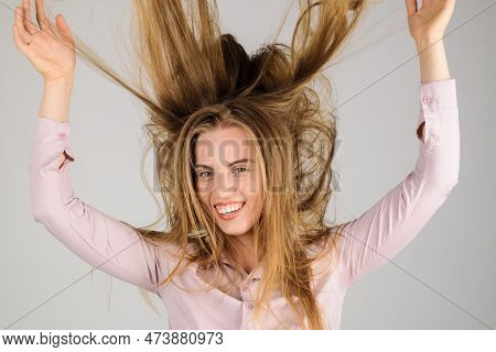 Smiling Woman With Long Disheveled Hair. Haircare. Happy Girl With Waving Hair. Fashion Woman Hairst
